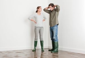 Water damaged flooring stress with two people