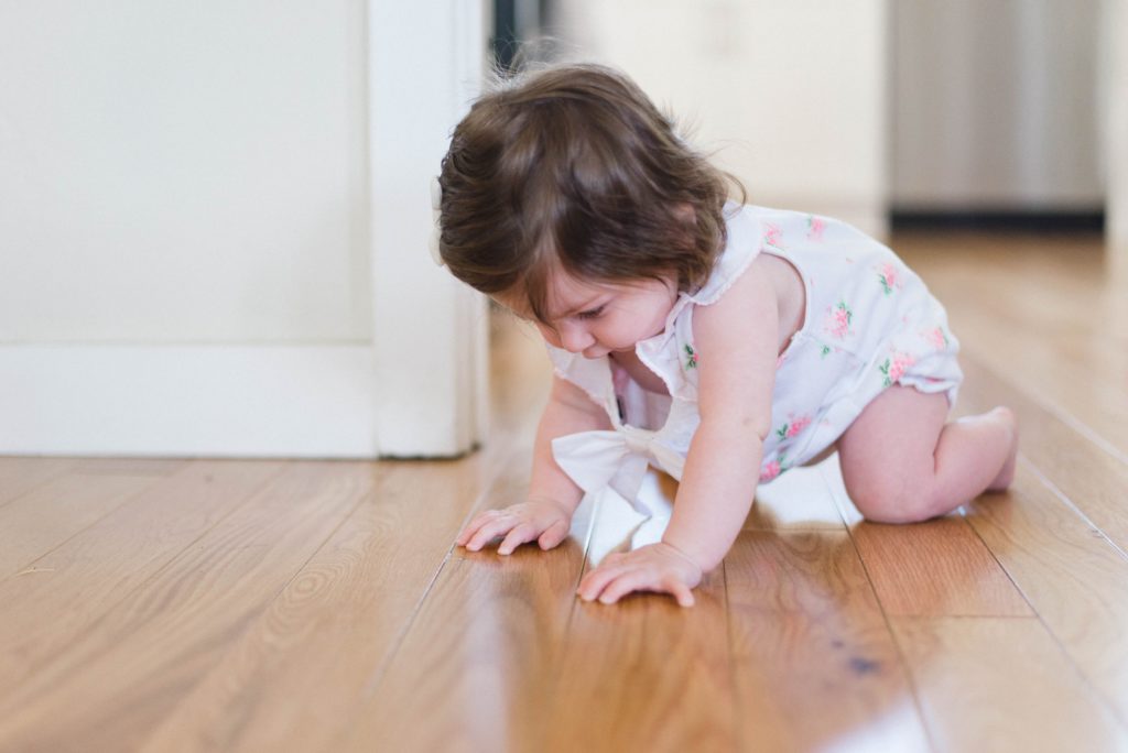Toddler crawling on timber floor