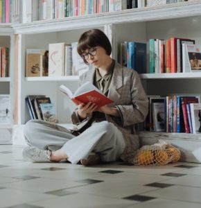 Woman reading on tile floor