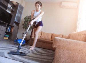 happy lady vacuuming