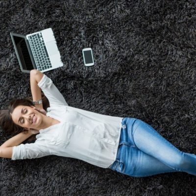 Woman lying on black carpet