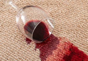 Red wine glass spilt over carpet