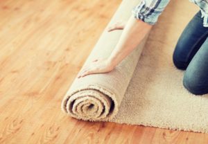 Installer unrolling carpet on the floor