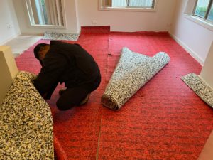 8mm Government Red Carpet Underlay being installed.