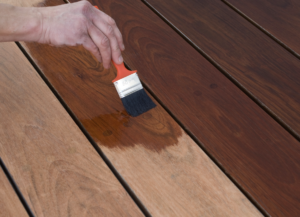 Sealing timber decking with lacquer.