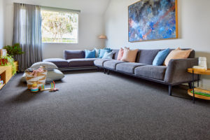 Polypropylene carpet installed in a living room with couches.